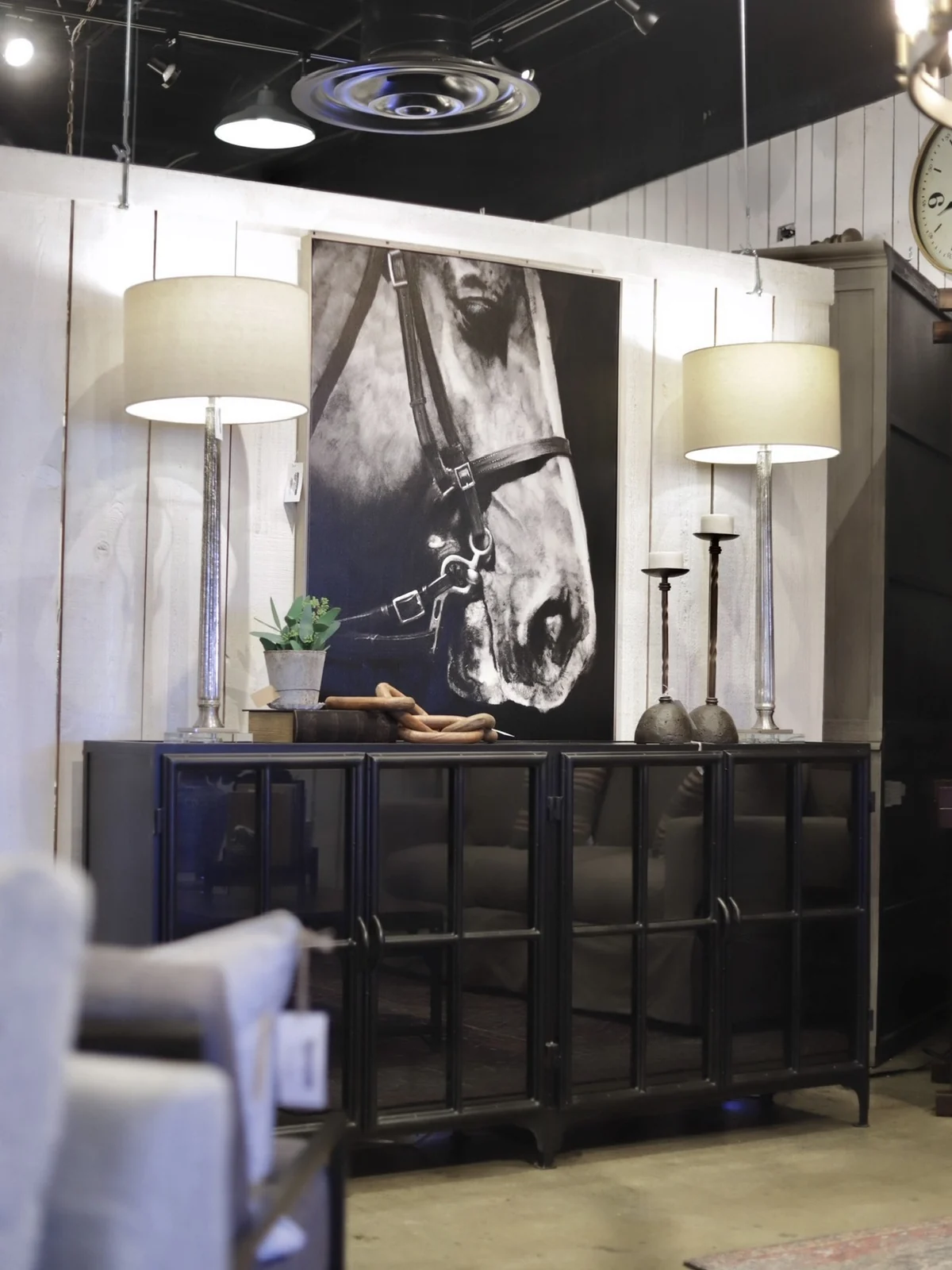 Console, artwork, and lighting displayed inside the JD's showroom