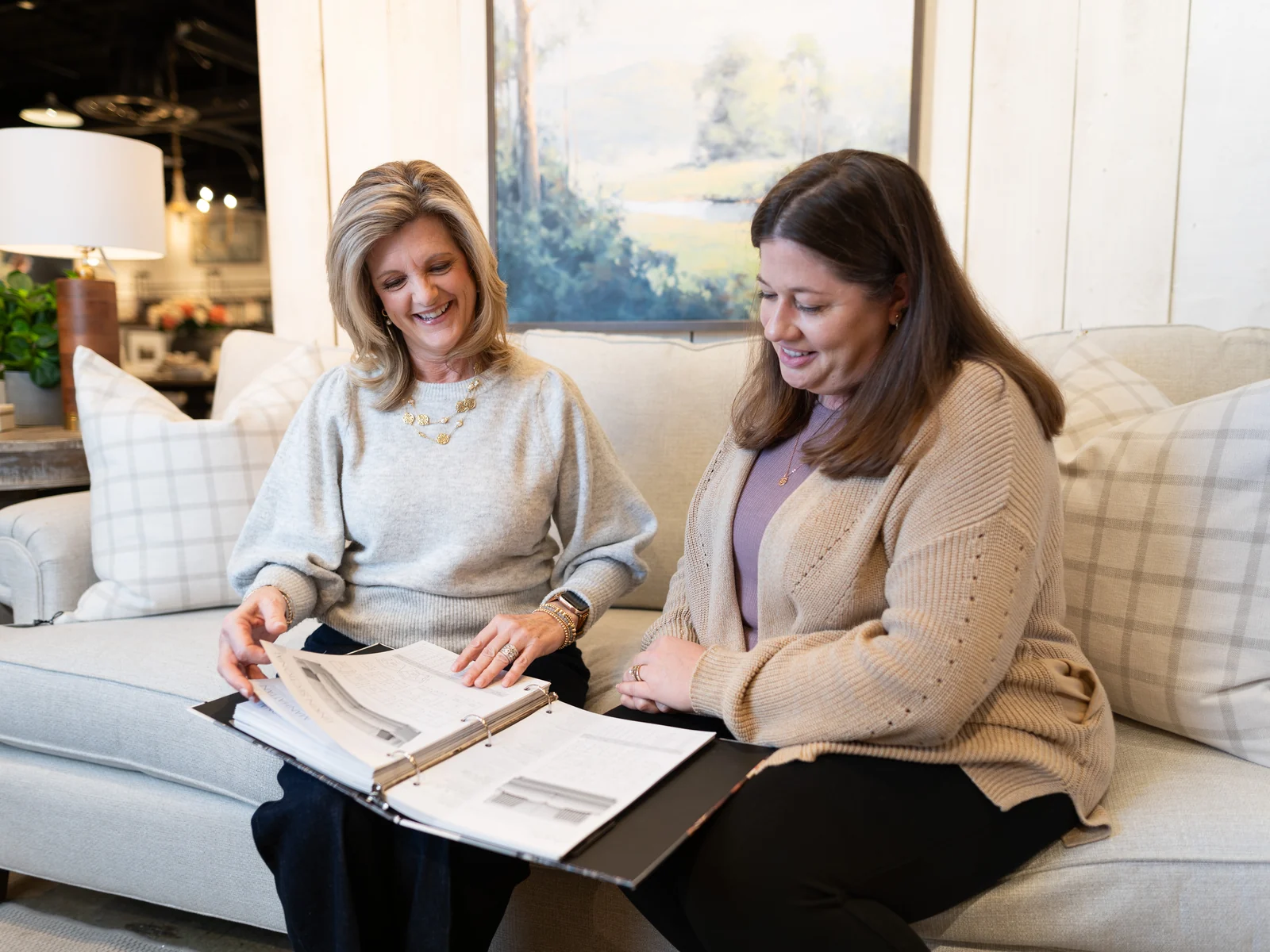 Two women review design selections together in the showroom