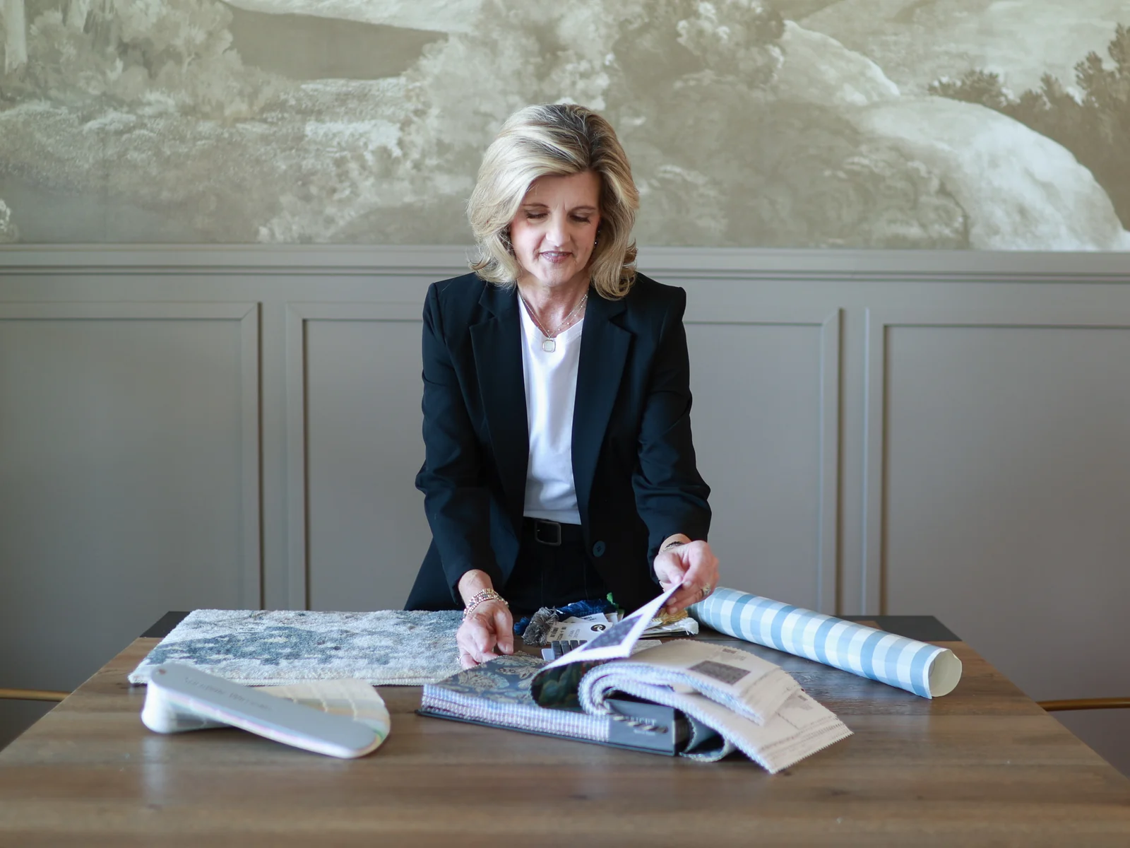Jennifer reviews fabric and material samples for an interior design plan
