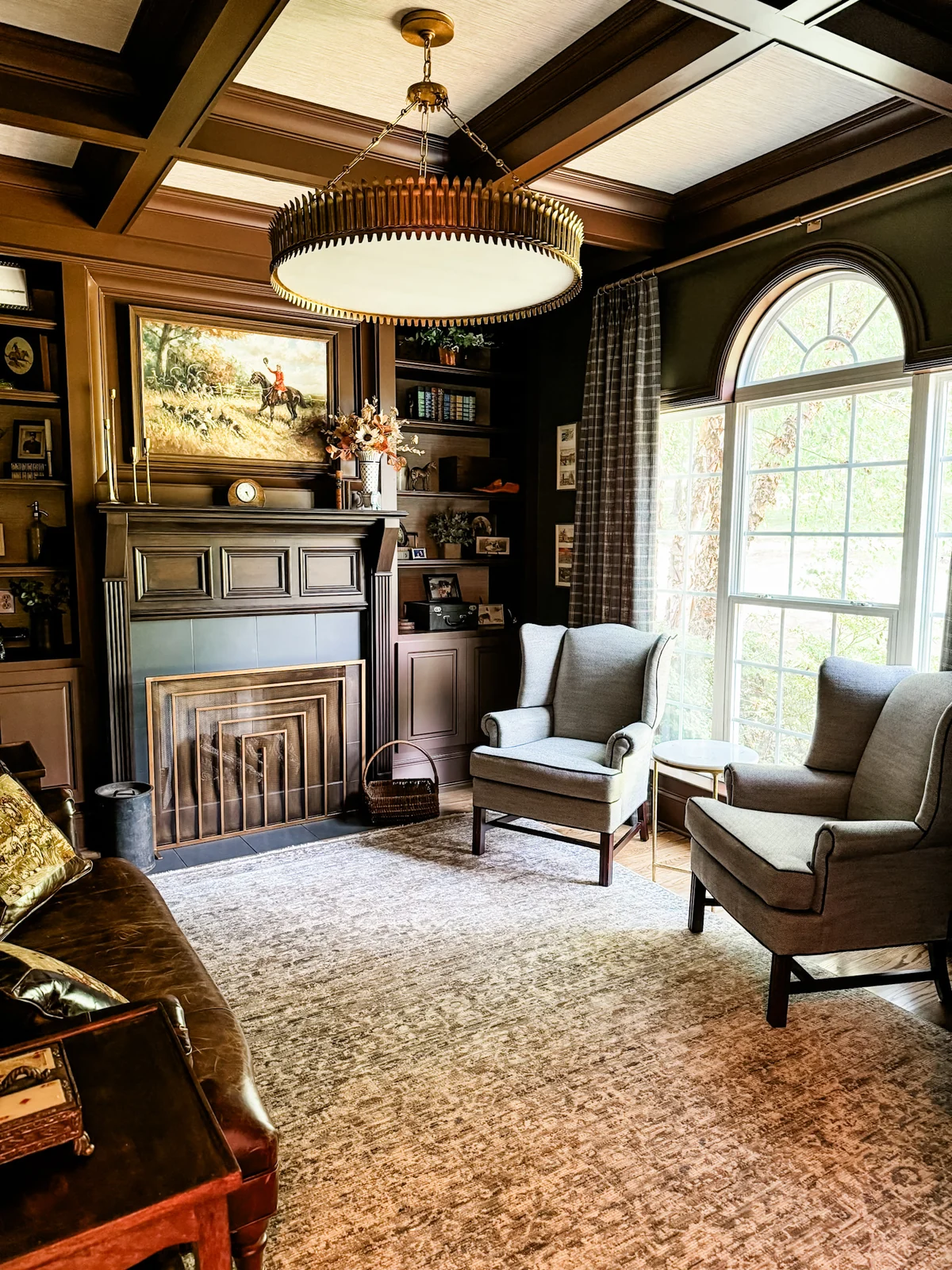 Traditional sitting room with built-in shelves, a fireplace, and upholstered chairs