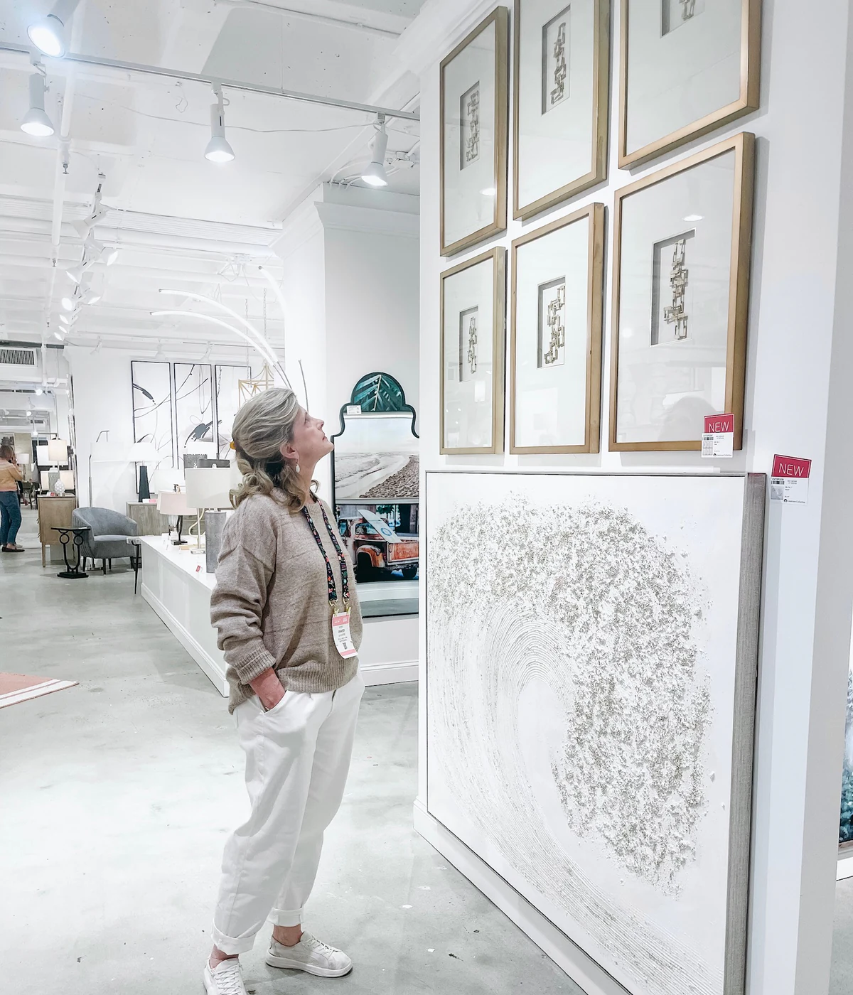 Jennifer reviews artwork while sourcing furnishings and finishing details