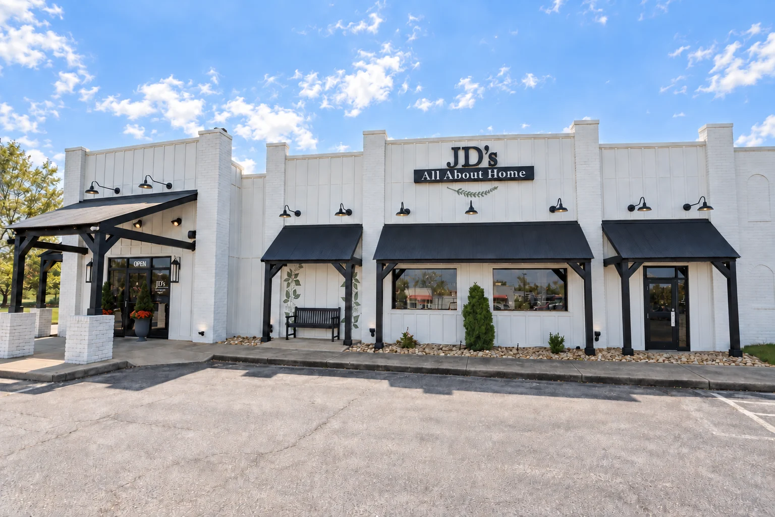 JD's All About Home storefront with white facade, black awnings, and the main entrance