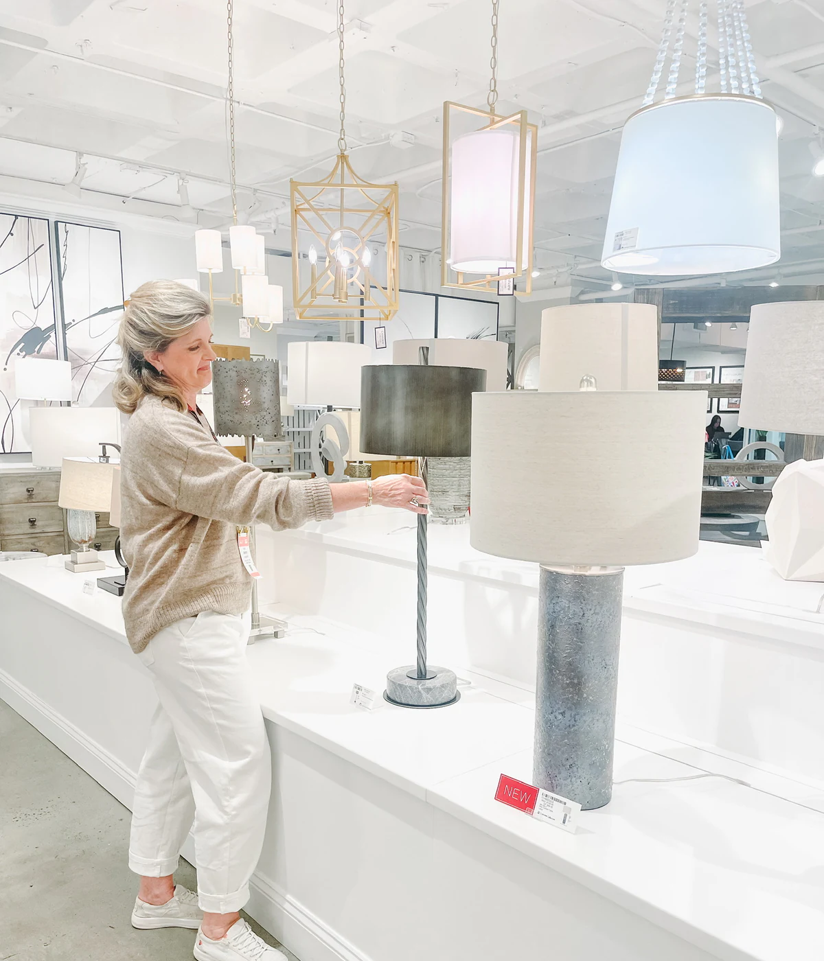 Jennifer compares lighting options during a sourcing visit